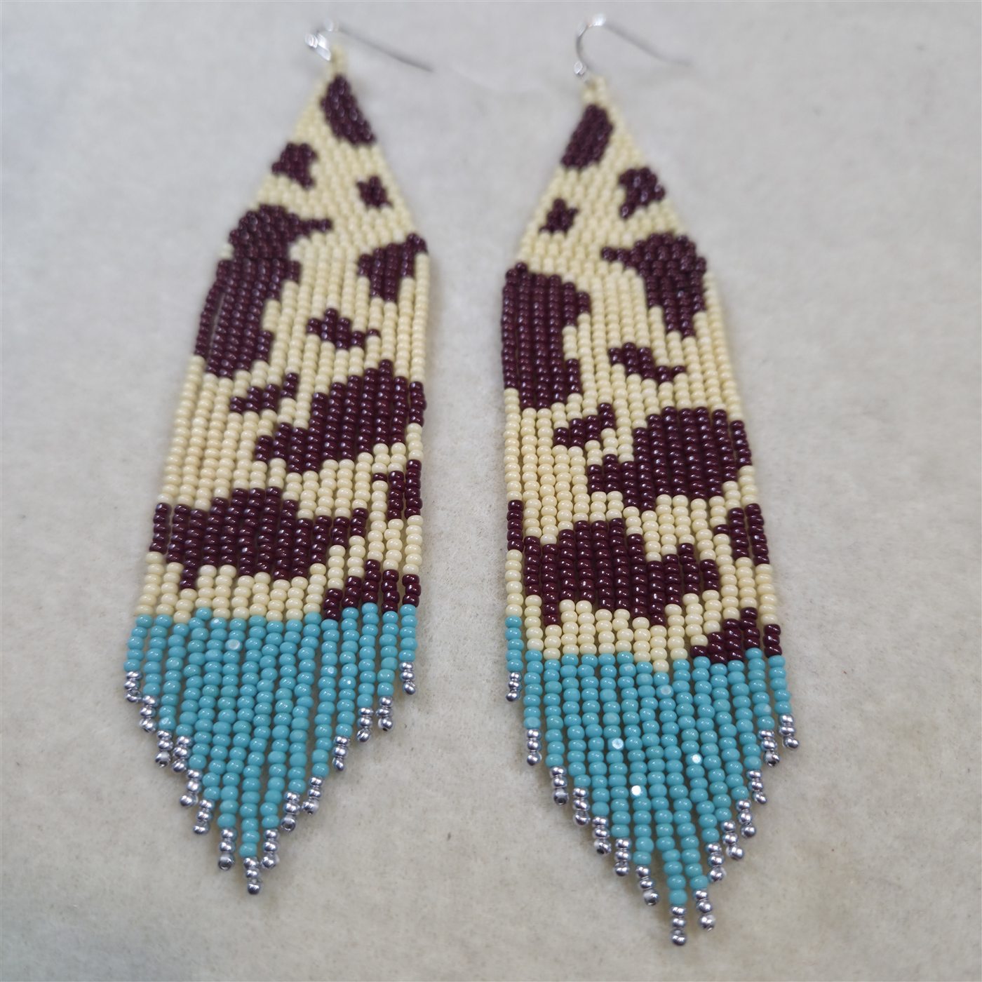 Purple, cream, and turquoise handmade beaded wolf fringe earrings